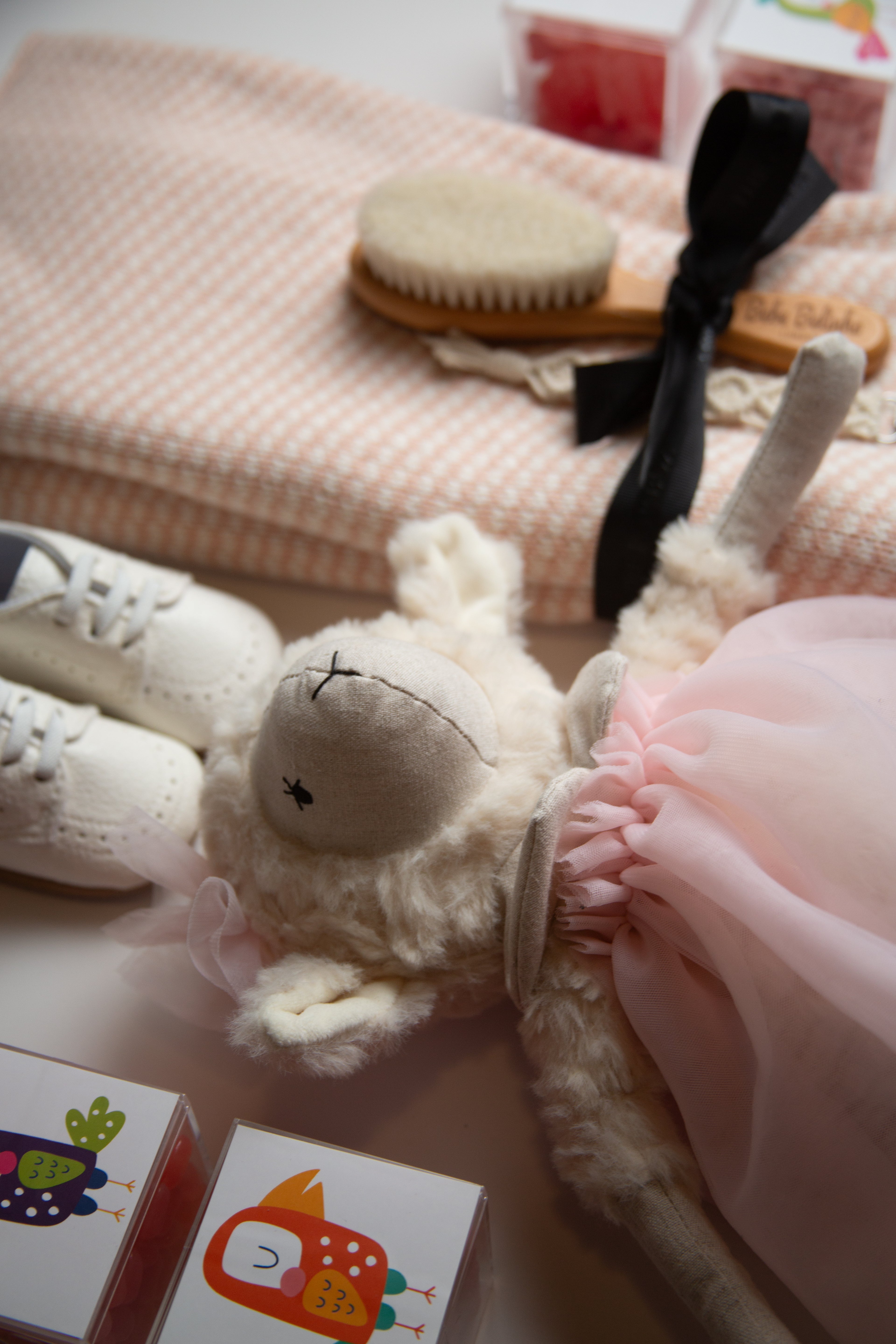Baby gift box with plush lamb, baby shoes, and elegant keepsakes from The POP BOX